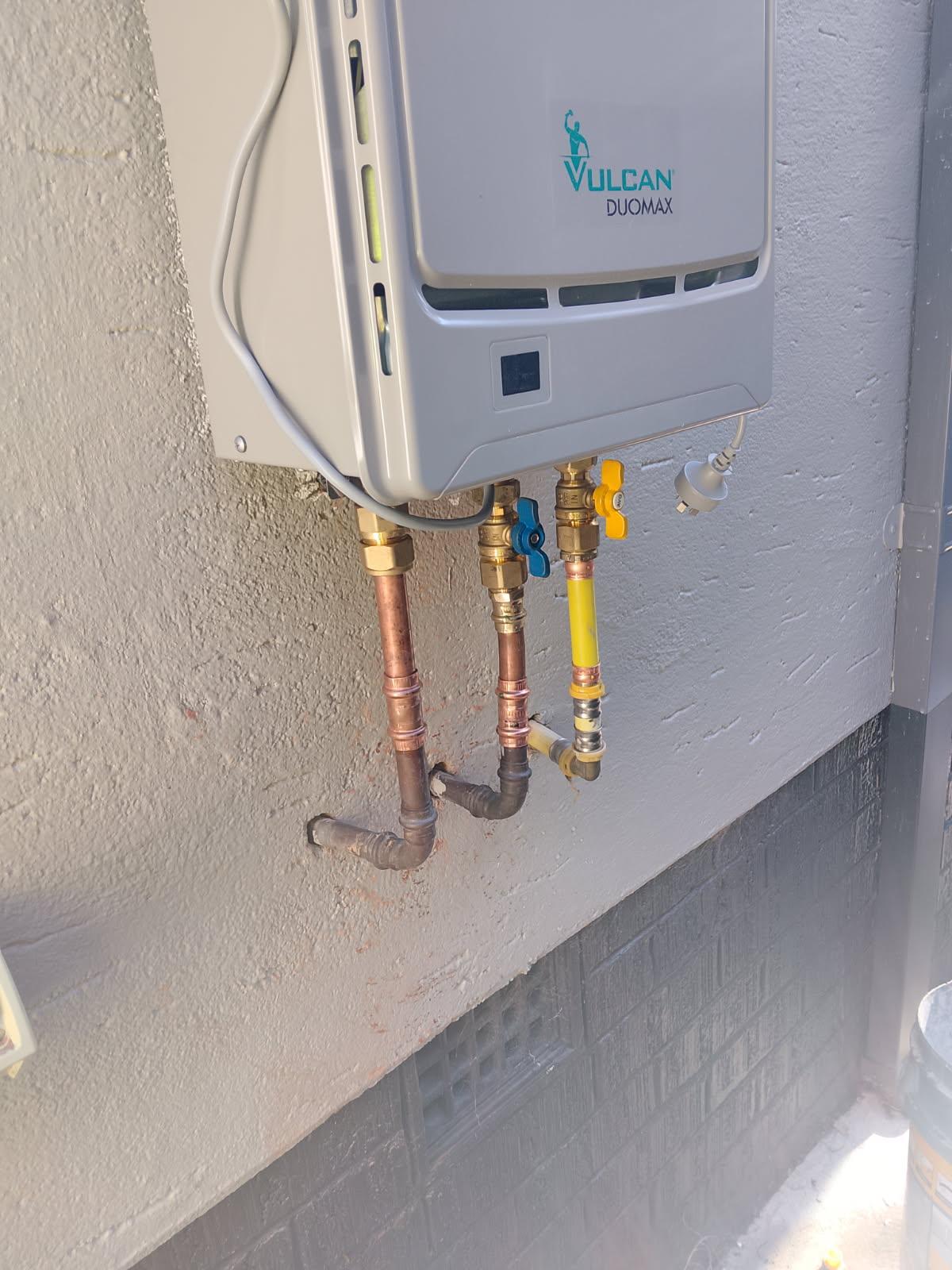 Copper and gas pipework connected to a Vulcan Duomax continuous flow hot water unit